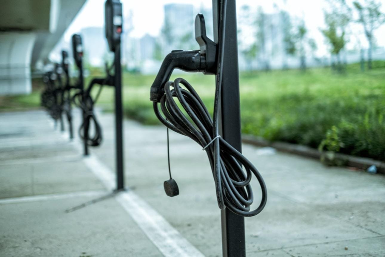 Tethered H07BZ5-F PUR AC EV charging cable installed on outdoor commercial charging post