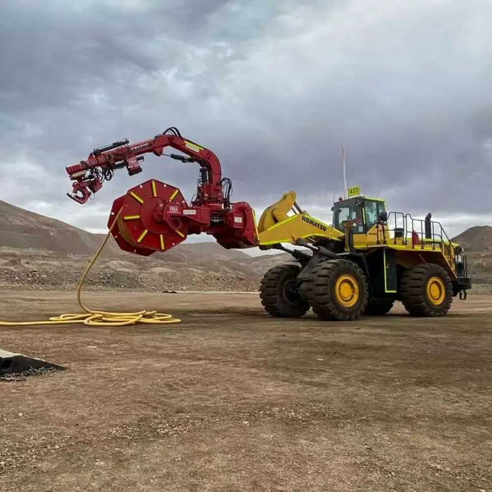 Wheel loader-mounted cable reeler handling flexible power cable in an open-pit mine