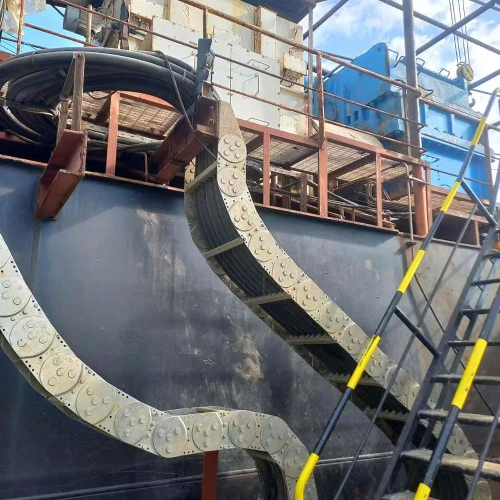 Heavy-duty drag chain carrying flexible power cables on port equipment
