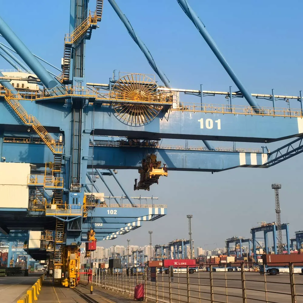 Ship-to-shore container cranes with a large cable reel at a container terminal