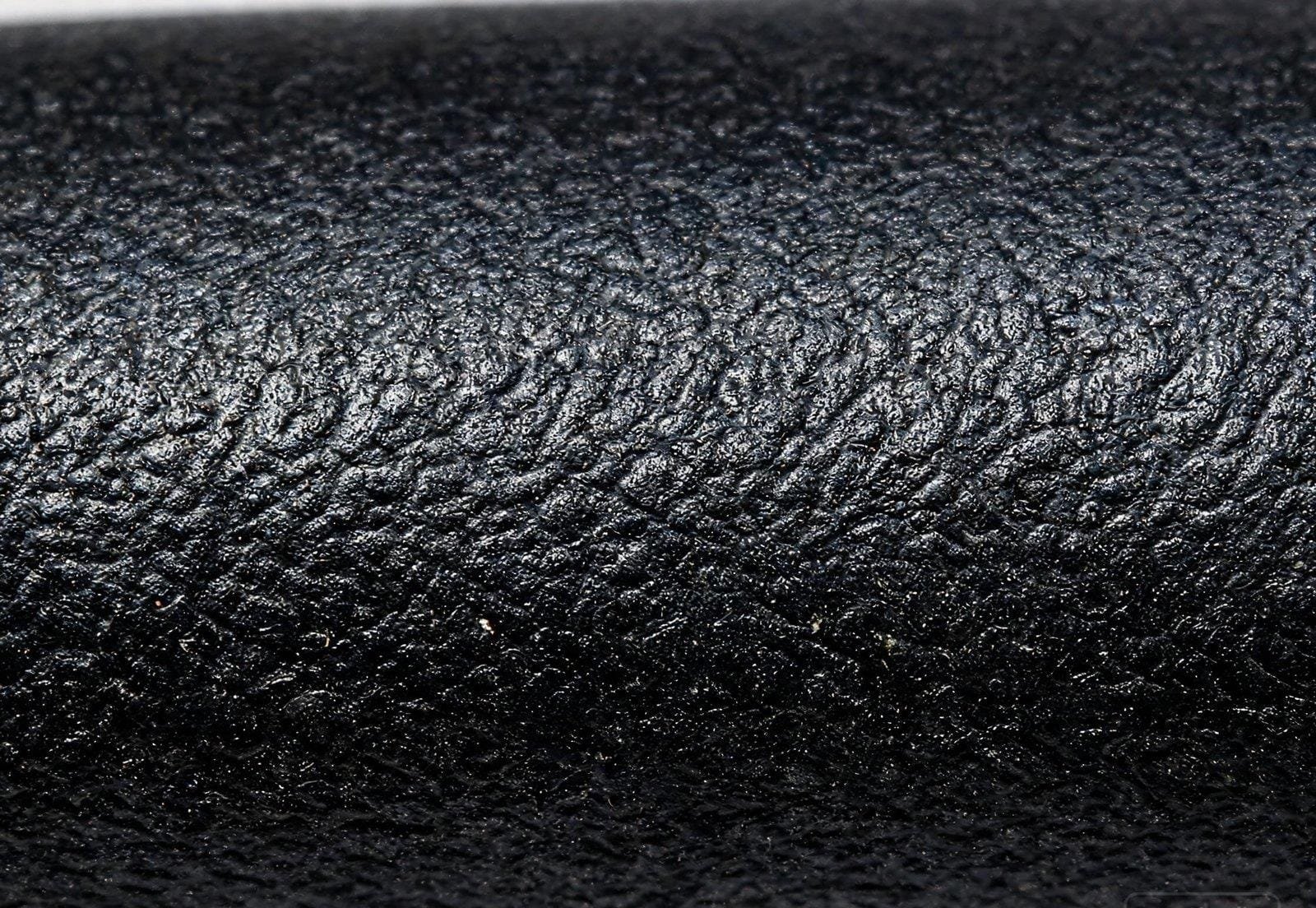 Close-up macro photograph of SOOW cable black rubber neoprene CPE jacket surface texture