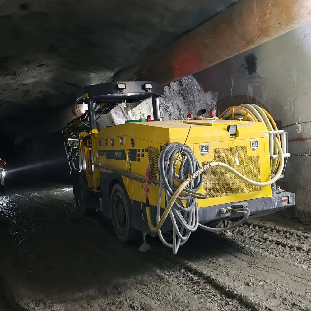 Underground mining service vehicle carrying flexible cables and hoses in a tunnel