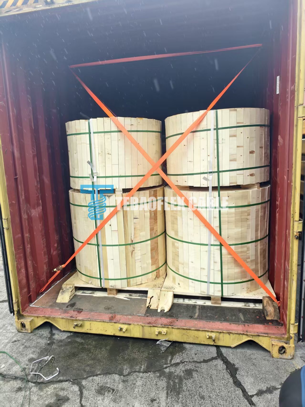 Wooden cable reels secured inside a freight container for the port cable export project
