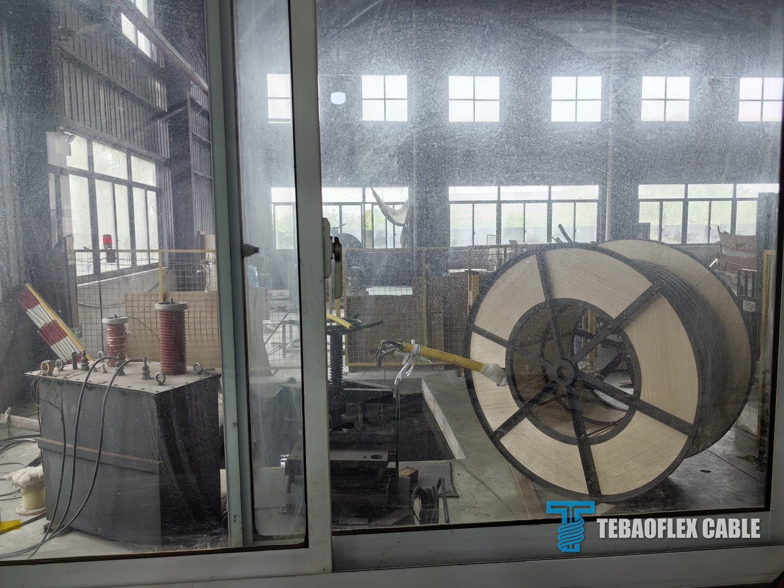 Full drum of yellow (N)SHTOEU-J reeling cable positioned in the factory test area